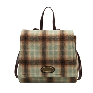Plaid vintage backpack with sage green wool fabric and brown leather straps on white background