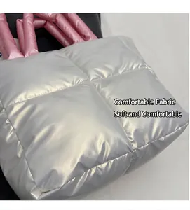 Close-up of quilted nylon fabric texture and soft pink padded handle on tote bag