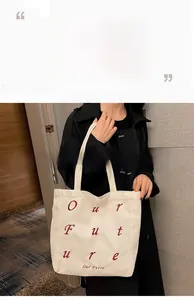 Detail of off-white corduroy tote bag with red Our Future embroidery and soft texture