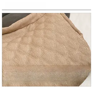 Detailed view of the soft khaki canvas tote bag with unique wavy scale texture