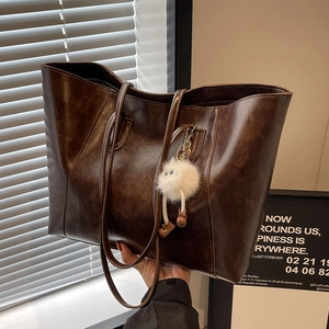 Retro dark brown leather tote bag with a cute white plush pendant and long straps