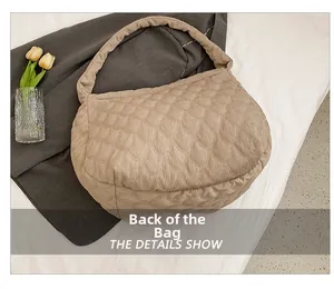 Back view of a beige quilted tote bag showing the wavy texture and corduroy material