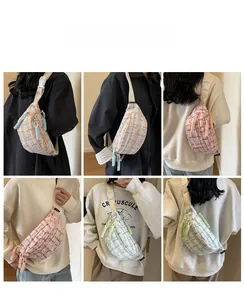 Detail view of colorful tweed crossbody bags with adjustable straps and woven zip pullers