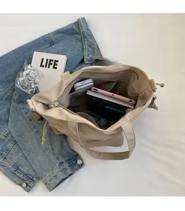 Spacious interior of beige canvas tote bag showing inner zipper pocket and large capacity
