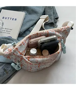 Interior view showing the large capacity of this checkered crossbody bag with essentials