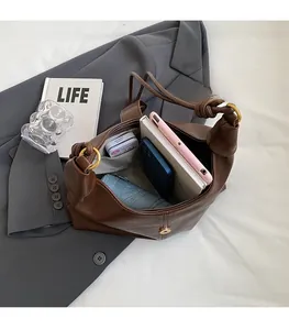 Spacious interior of dark brown leather tote bag showing storage for daily essentials