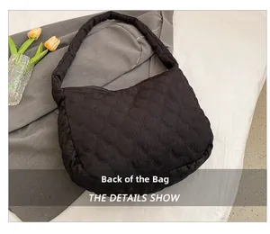 Detailed back view of the black quilted tote bag showing unique scalloped texture pattern