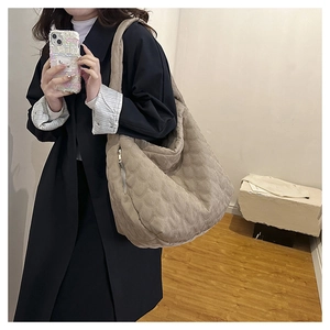 Close-up of beige quilted corduroy tote bag showing soft texture and large capacity