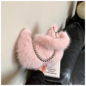 Détail de la fourrure synthétique rose et de la chaîne à billes sur un sac seau chic