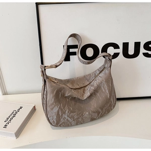 Détail du grand sac hobo taupe plissé avec fermeture éclair dorée et finitions métalliques