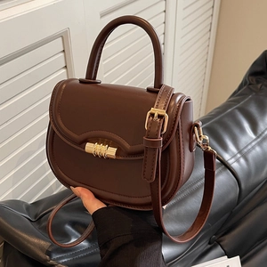 Retro dark brown leather saddle bag with gold cylindrical lock and top handle strap
