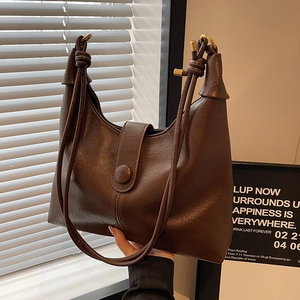Brown vintage leather tote bag with unique knotted drawstring shoulder strap