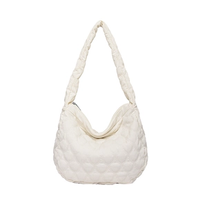 Cream heart-quilted corduroy tote bag with thick shoulder strap and top zipper