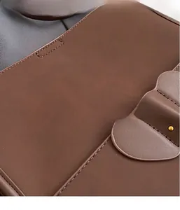 Detail showing high-quality stitching and metal dot decor on dark brown matte leather tote bag