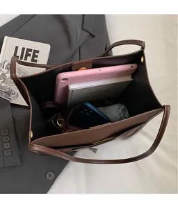 Spacious interior of a vintage brown tote bag with multiple compartments for essentials