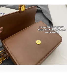 Detail view of brown PU leather bag with hidden golden magnetic clasp and chain strap