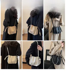 Detail shots of khaki, cream, and black drawstring bucket bags with chain accents