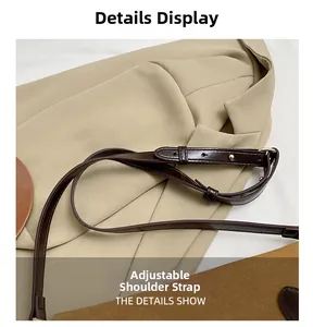 Macro detail of the adjustable brown leather shoulder strap with metallic buckle