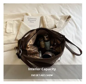 Macro detail of the spacious striped interior and zipped pocket of the dark brown tote bag