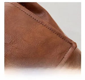 Close-up of high-quality stitching on brown leather tote bag showing fine craftsmanship