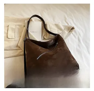 Macro shot of vintage dark brown faux leather tote bag with decorative diagonal zipper