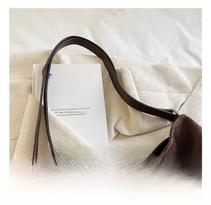 Detail of coffee brown leather tote showing oil texture and silver metal zipper