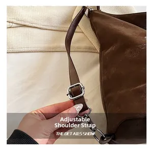 Detail view of adjustable dark brown leather shoulder strap with silver buckle