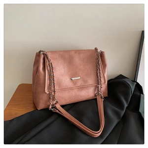 Detail of dusty rose tote bag showing faux leather texture and silver metal hardware
