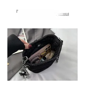 Interior view of tweed bucket bag showing large capacity for phone and cosmetics