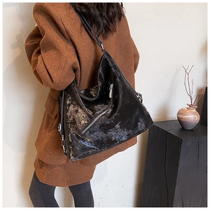 Close-up of vintage black leather tote bag with functional diagonal metal zipper
