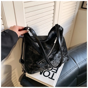Macro detail of soft vintage black leather tote bag with silver zipper closure