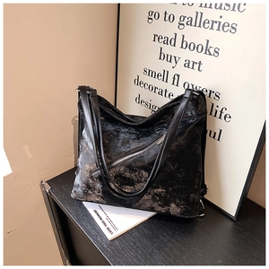 Detailed view of the dark grey tote bag with vintage texture and front zipper detail