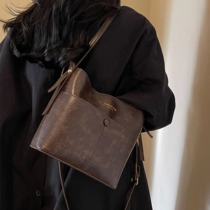 Retro dark brown bucket shoulder bag with vintage texture and adjustable strap