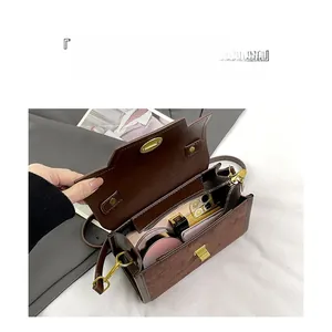Internal view of brown crossbody bag showing organized compartments and zipper pocket