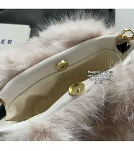 Detail of plush bucket bag featuring a secure golden magnetic buckle and white lining