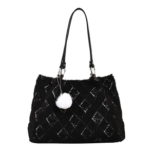 Black plush lamb wool tote bag with white diamond lattice pattern and pompom charm