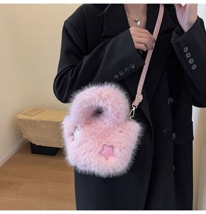 Detailed close-up of the fluffy pink faux fur bucket bag with sequin star accents