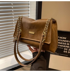 Brown vintage faux leather tote bag with gold chain strap and metallic buckle detail