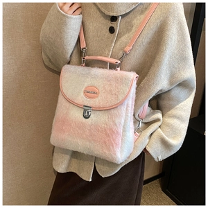 Close-up of pink and white plush backpack featuring soft mohair texture and leather trim