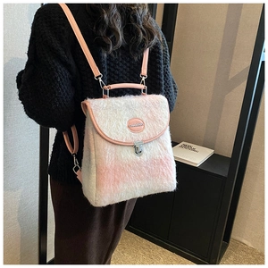 Detail of pink and white checkered plush backpack with metal clasp and leather handle