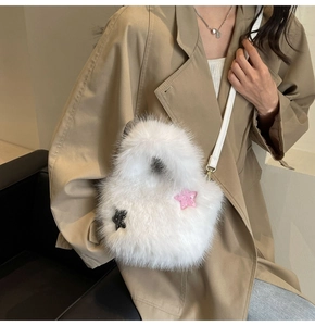 Close-up of fluffy white faux fur crossbody bag with pink and black sequin star details