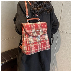 British style plaid backpack in red and beige tweed with brown leather trim on model