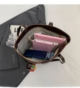 Detailed interior of large brown tote bag showing spacious storage for daily essentials