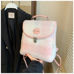 Close-up of pink and white checkered plush backpack featuring a metal lock and leather handle
