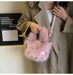 Detail of pink plush bucket bag featuring soft faux fur texture and star patch decoration