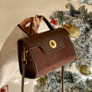 Vintage brown leather crossbody bag with suede stitching and gold rotating lock by Christmas tree
