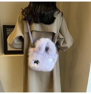 Close-up of lavender fuzzy faux fur bag with star patches on a trench coat outfit