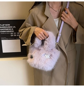Detail of purple faux fur bucket bag featuring a sequined silver star and leather strap