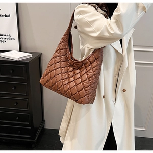 Detail of brown quilted rhombus texture and spacious hobo bag design for women