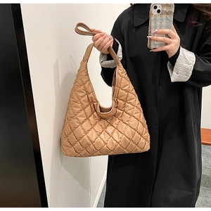Detailed view of khaki quilted tote bag featuring a padded diamond lattice design